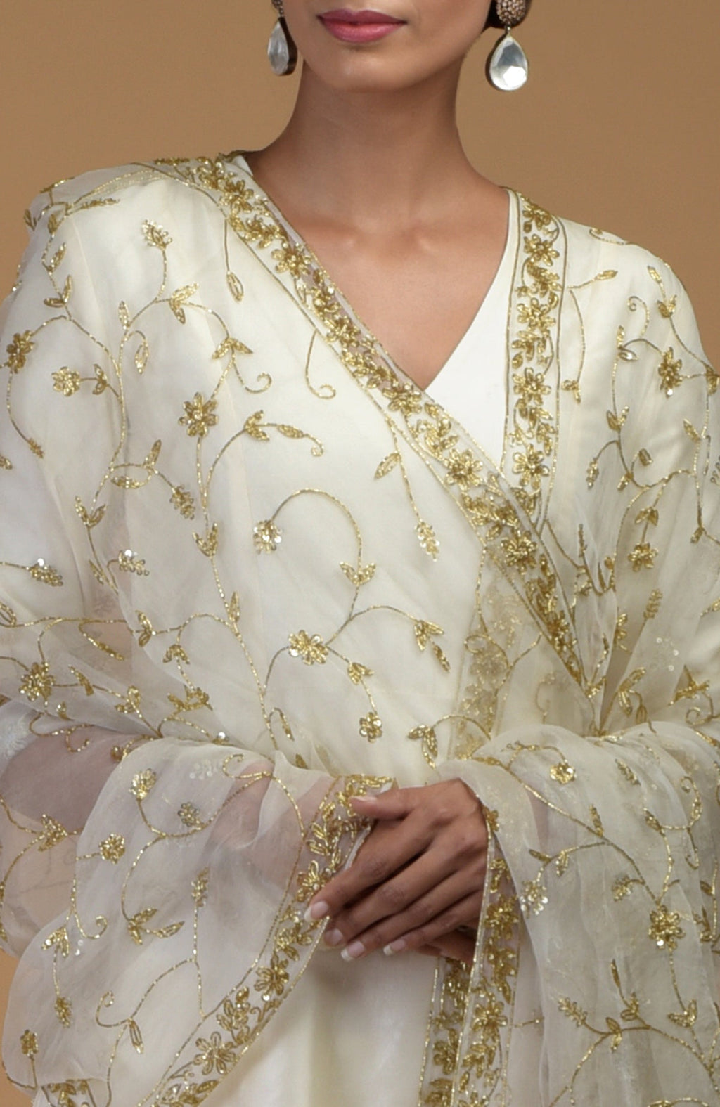 An ivory-gold zardozi hand-embroidered dupatta with a suit is shown on a model.