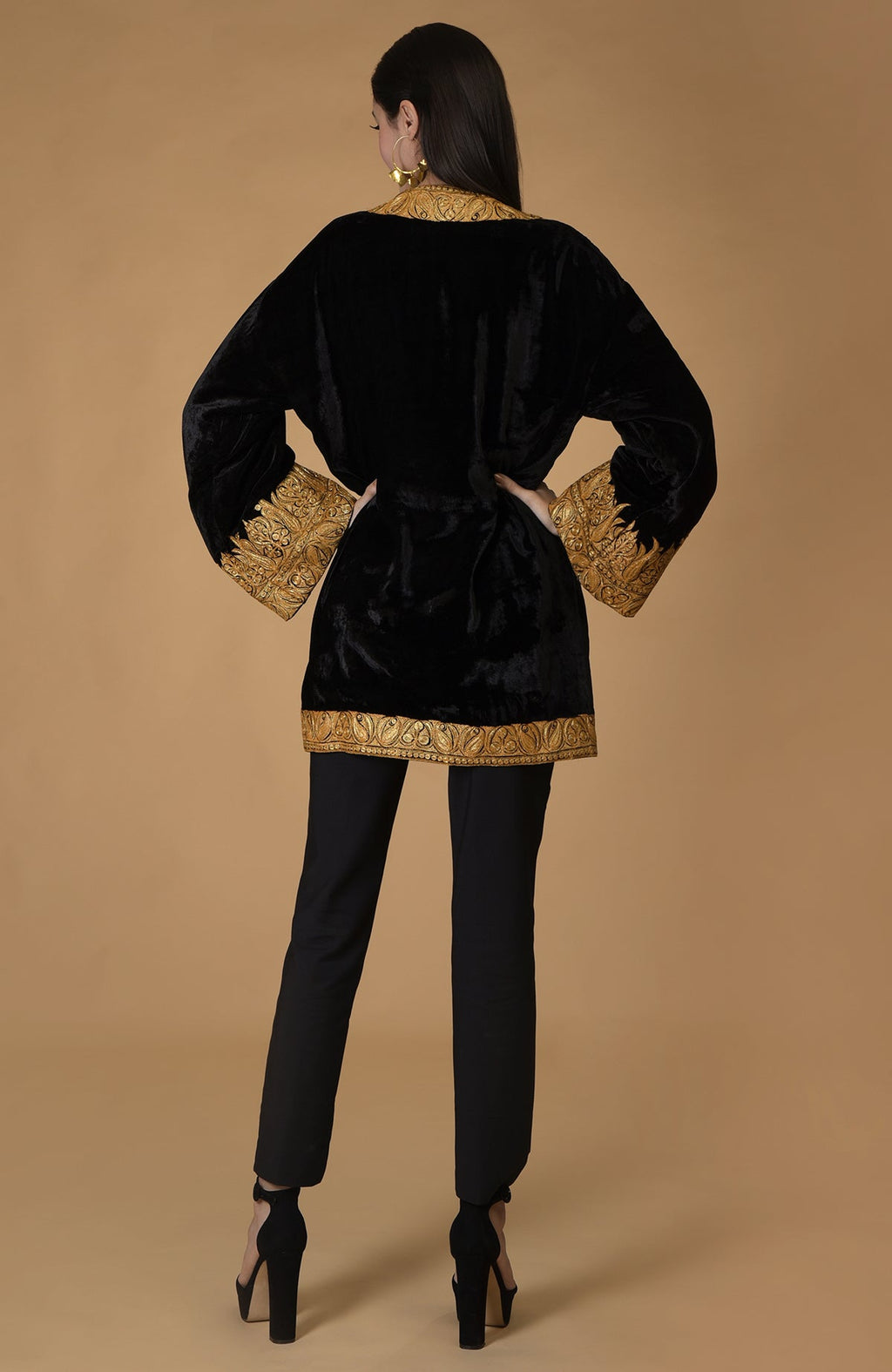 Black velvet kimono jacket with gold Kashmiri tilla embroidery on a model.