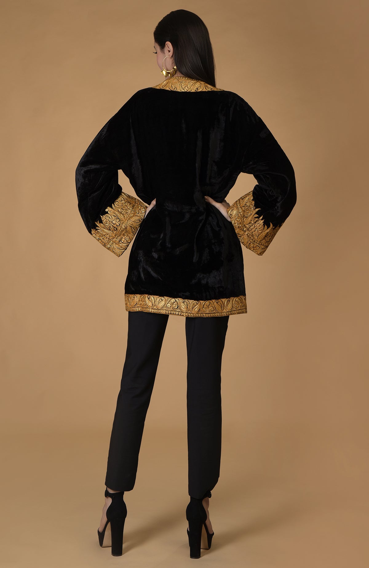 Black velvet kimono jacket with gold Kashmiri tilla embroidery on a model.