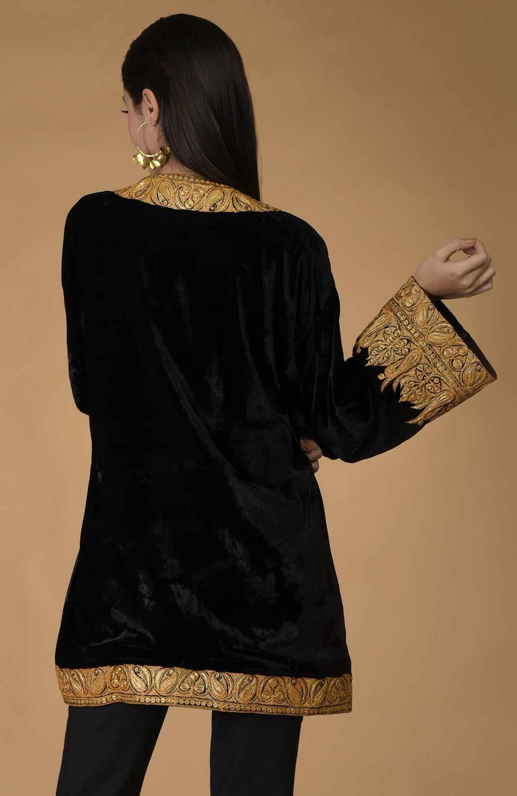 Black velvet kimono jacket with gold Kashmiri tilla embroidery on the neckline, sleeves, and hem.