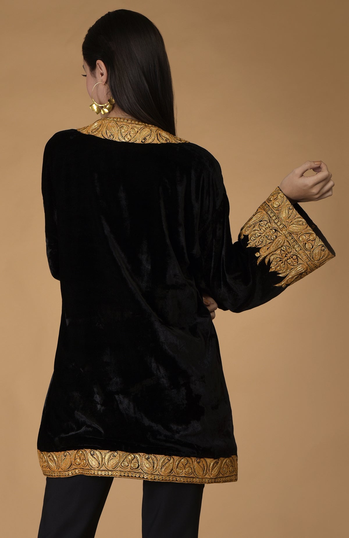 Black velvet kimono jacket with gold Kashmiri tilla embroidery on the neckline, sleeves, and hem.