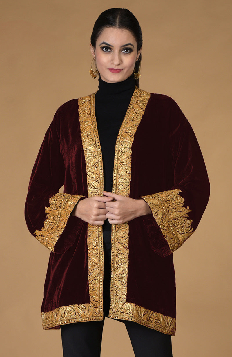 Woman in a black Kashmiri Tilla embroidered kimono jacket.