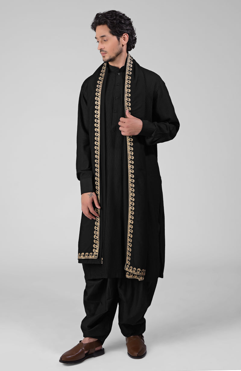 Black pintuck Pathani kurta with matching salwar and gold embroidered tilla dupatta.