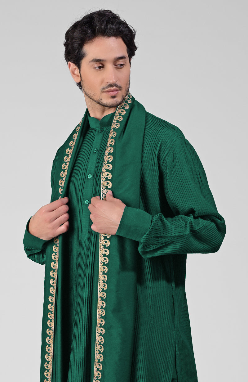 Emerald green pintuck kurta with pathani salwar and gold tilla embroidered dupatta.