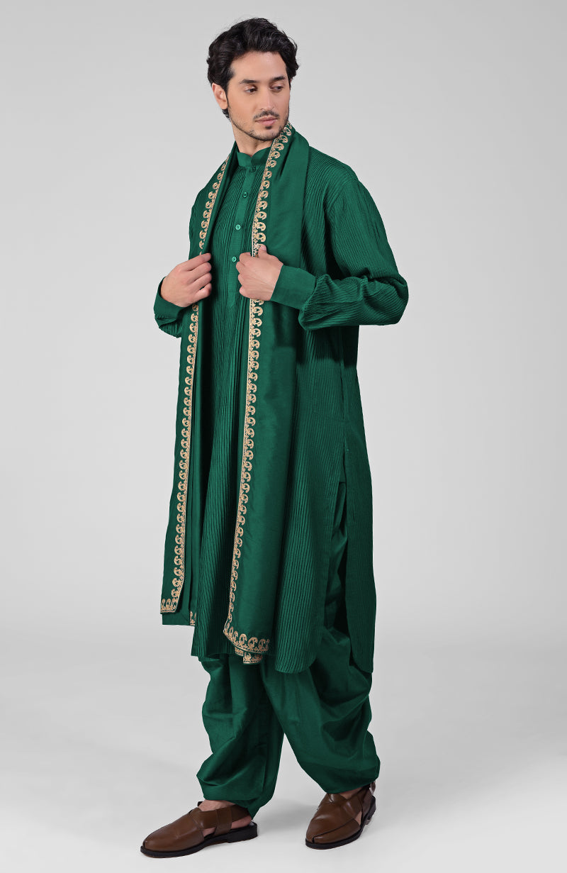 Scarlet red pintuck kurta with pathani salwar and gold tilla embroidered dupatta.