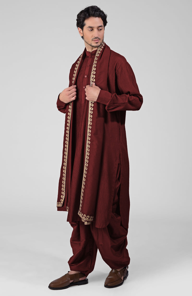 Scarlet red pintuck kurta with pathani salwar and gold tilla embroidered dupatta.