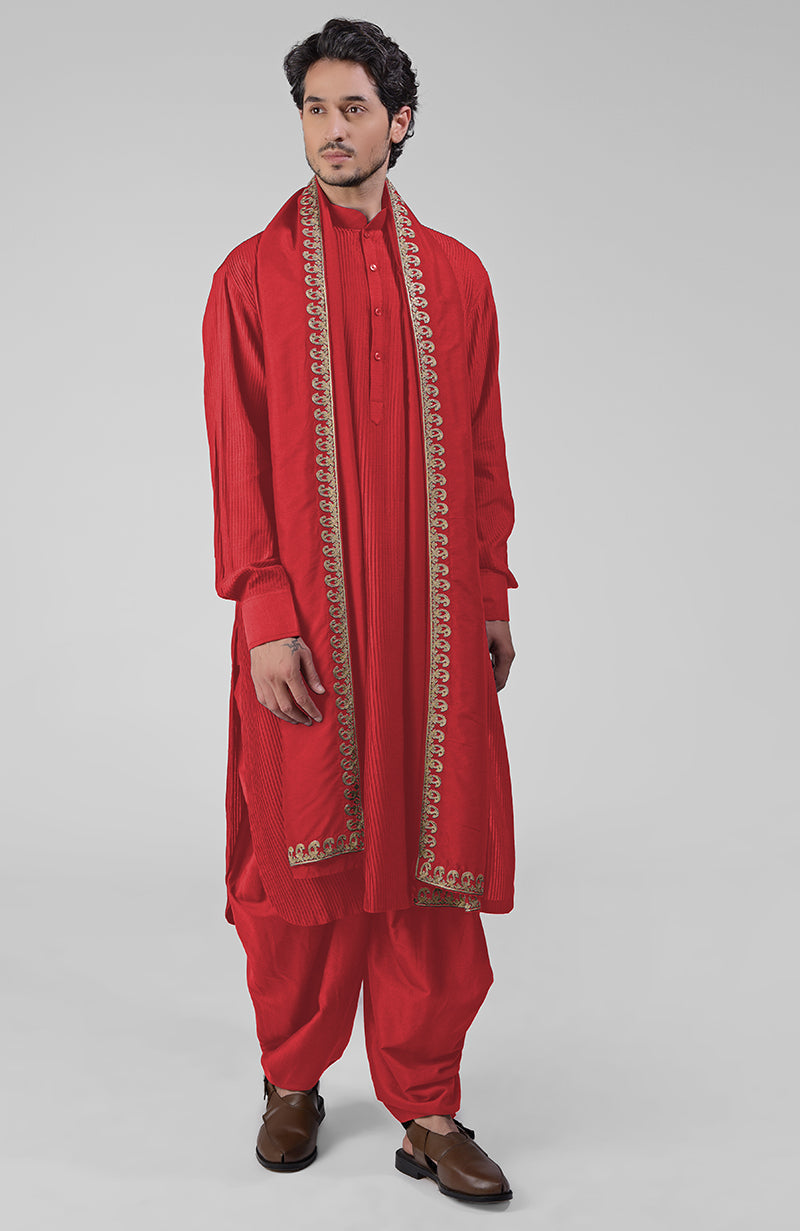 Scarlet red pintuck kurta with pathani salwar and gold tilla embroidered dupatta.