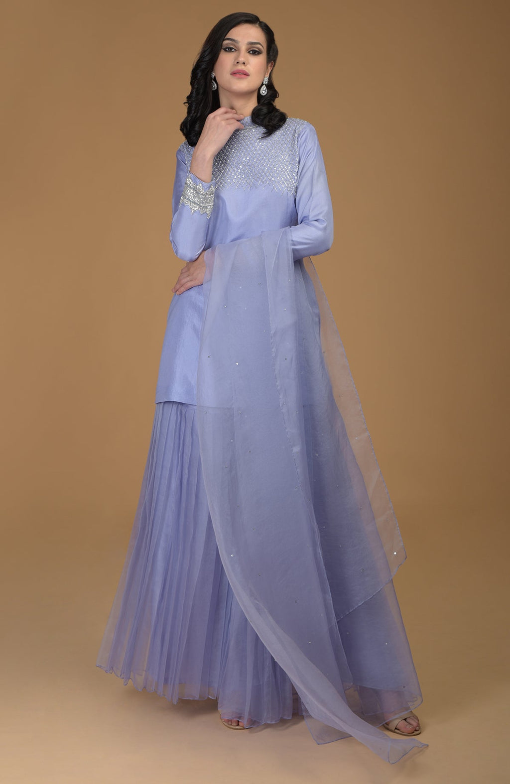 A woman models a pastel lilac Inara Zardozi hand-embroidered gharara set.