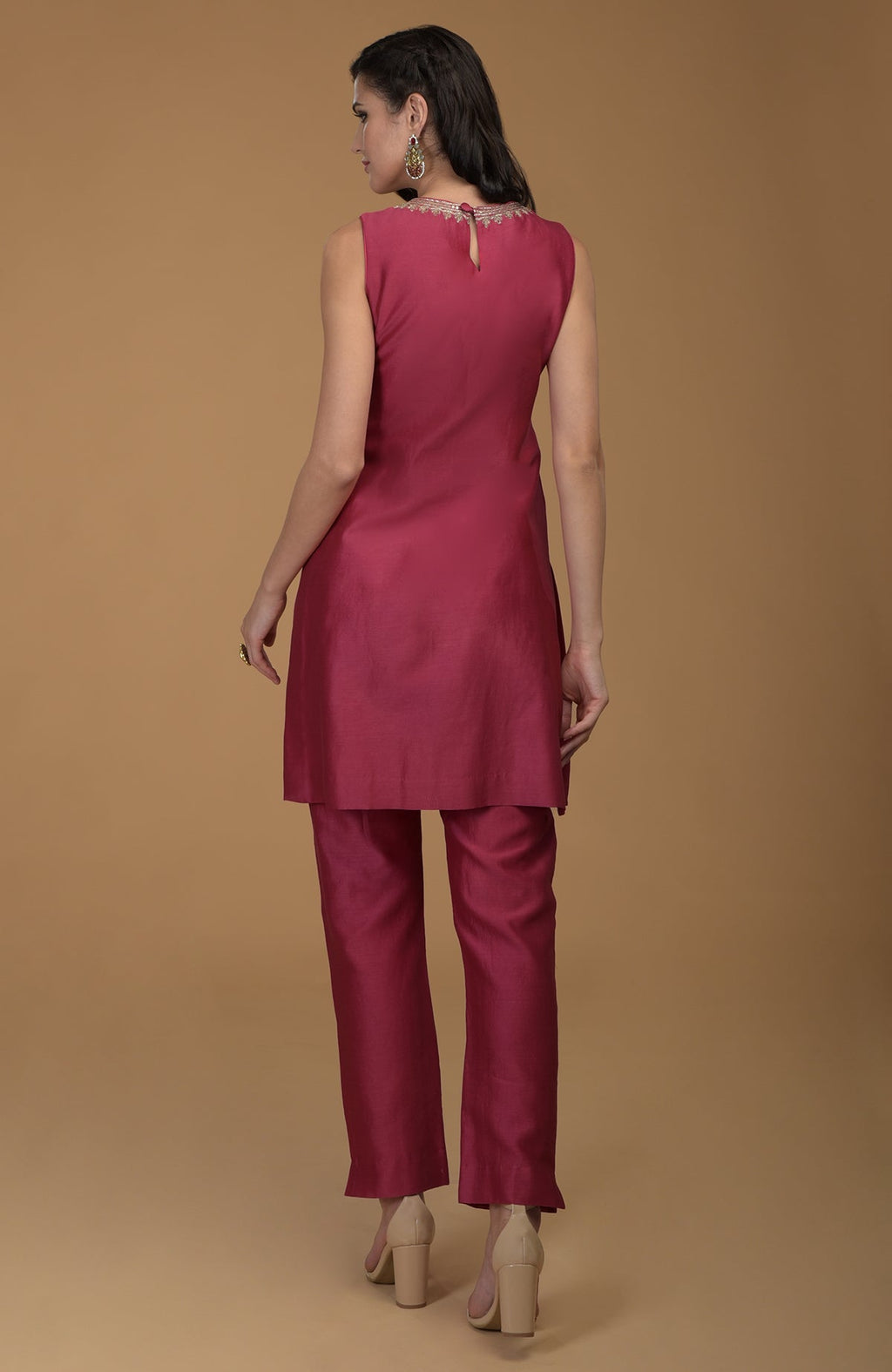 Ruby red zardozi hand embroidered suit with a sleeveless tunic and pants.
