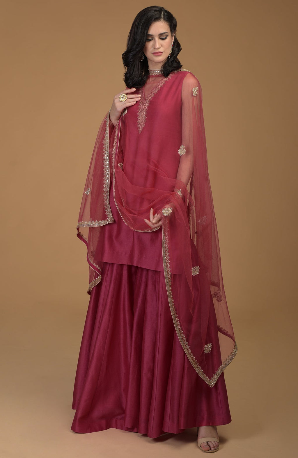 Ruby red zardozi hand-embroidered gharara suit with a sheer dupatta.