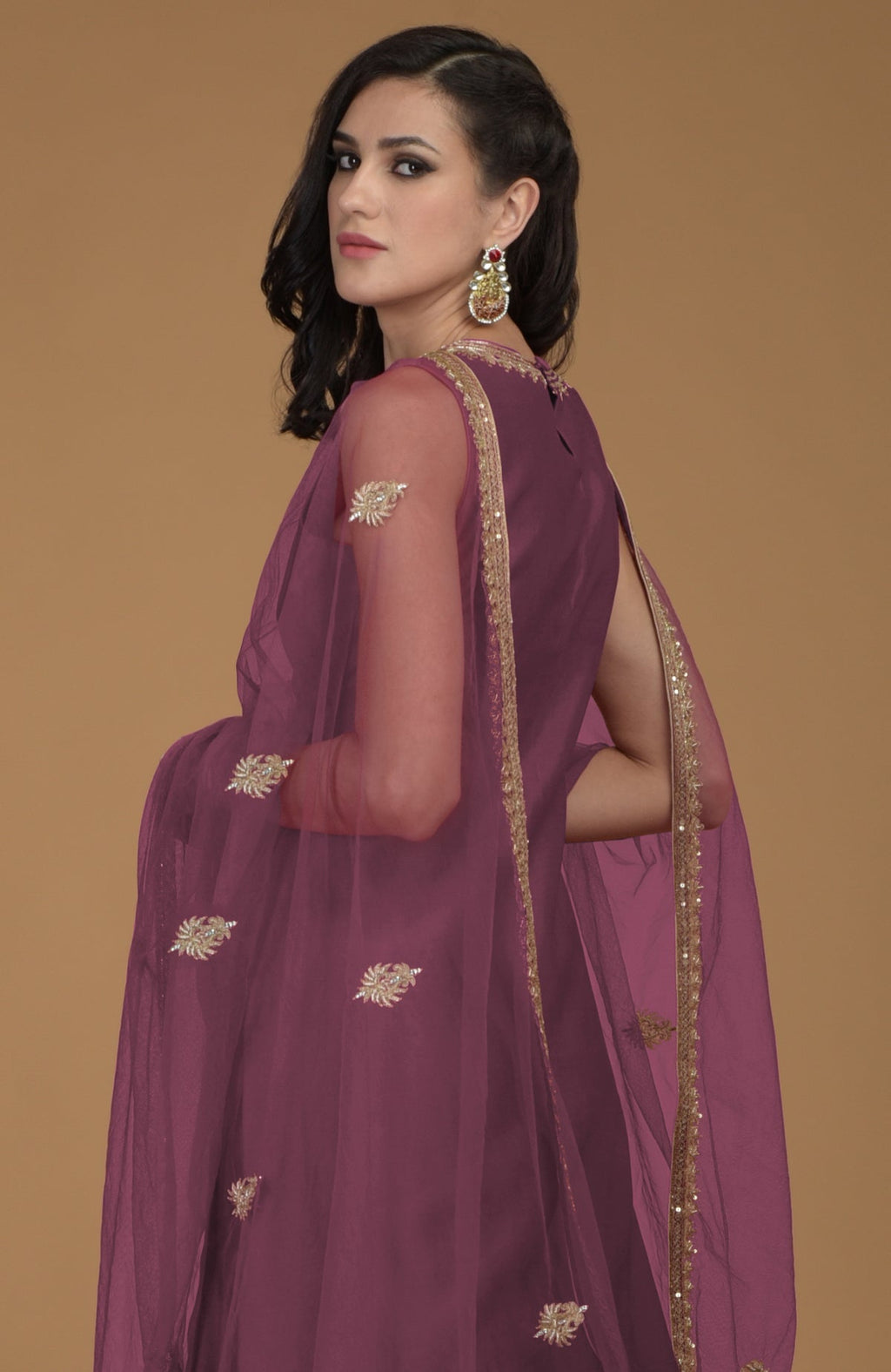 Burgundy purple gharara suit with gold hand embroidered zardozi on neckline and dupatta.