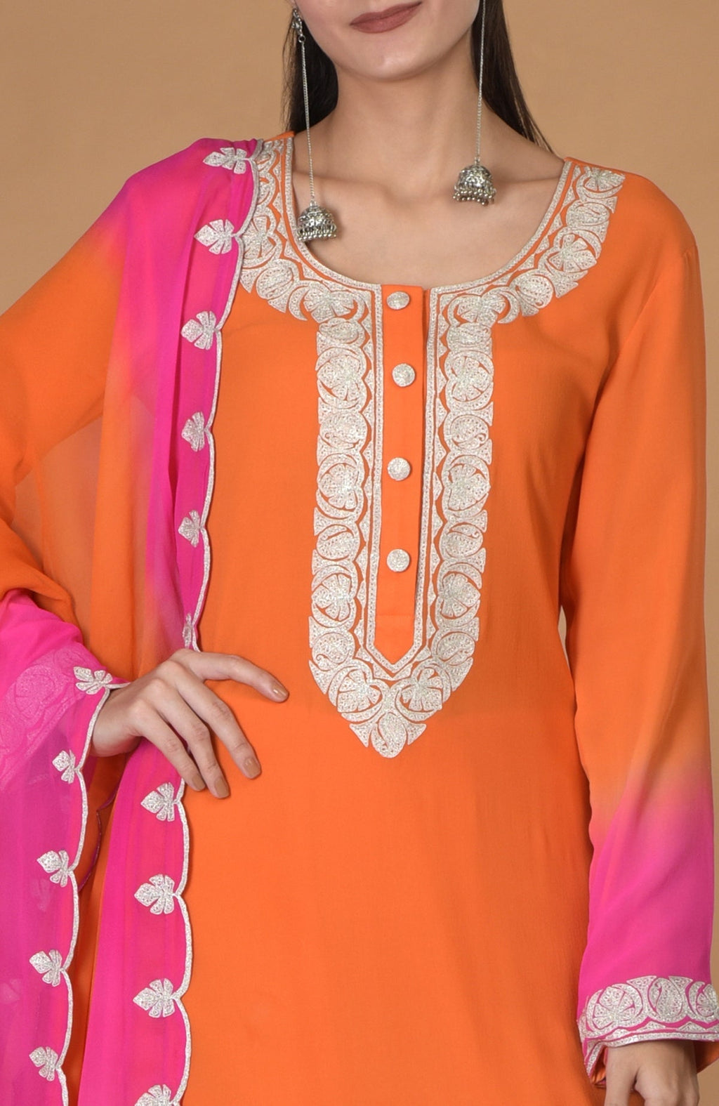 Orange-hot pink ombre kurta set with tilla embroidery and silver jhumka earrings.