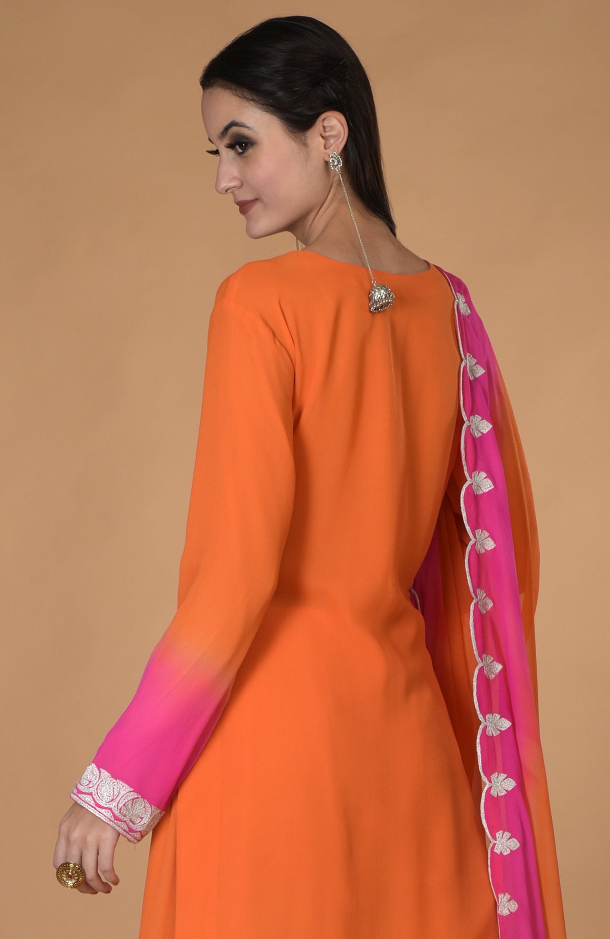Orange-hot pink ombre kurta set with tilla embroidery and a long earring.