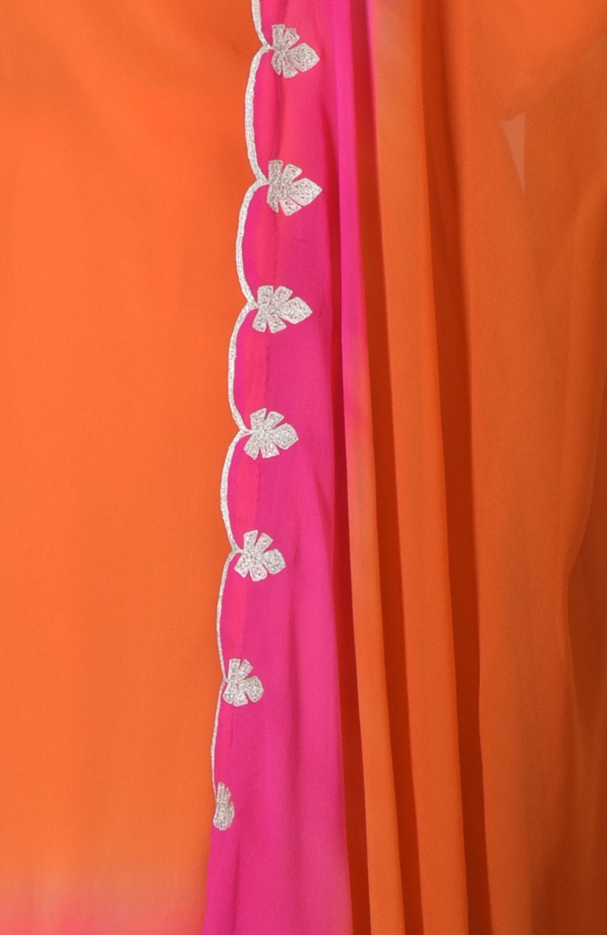 Orange and hot pink ombre fabric with silver tilla embroidery.