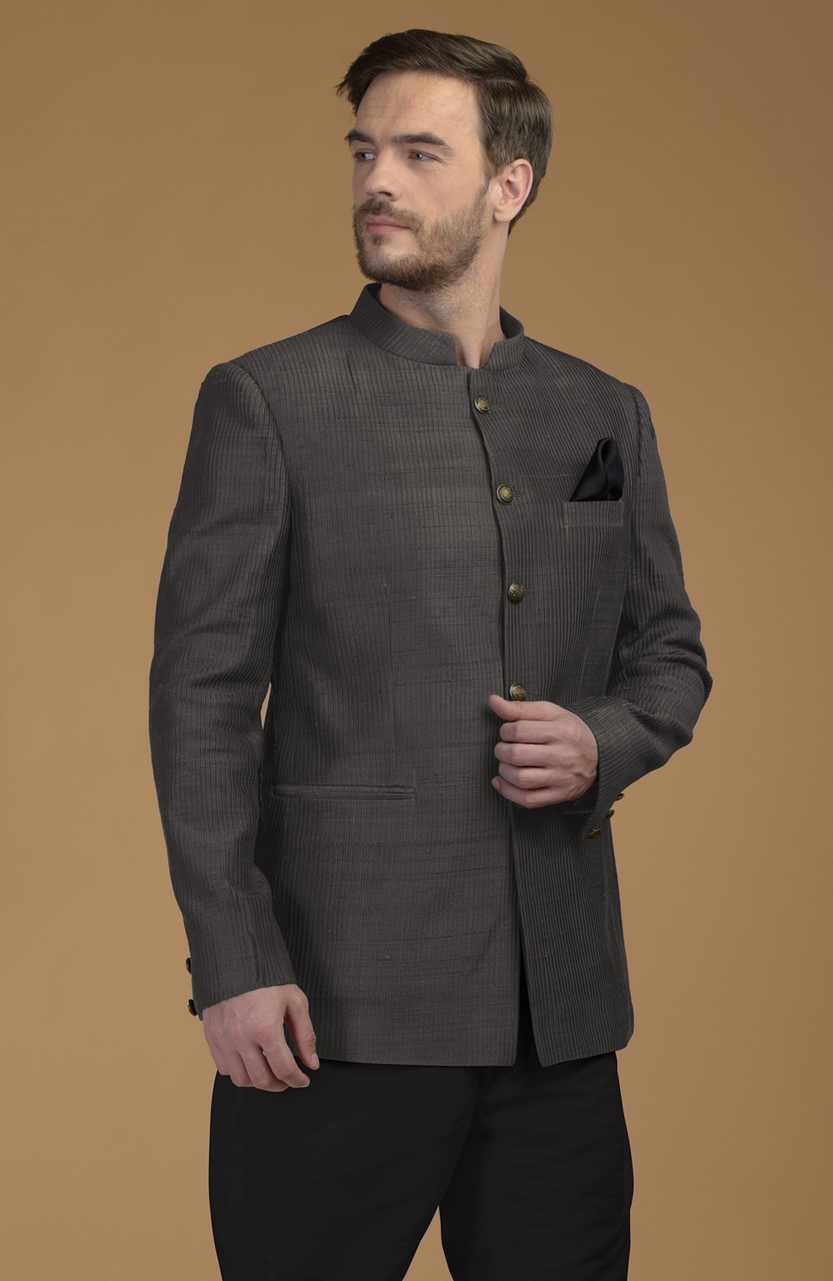 Charcoal grey pintuck raw silk Bandhgala jacket with a black pocket square.