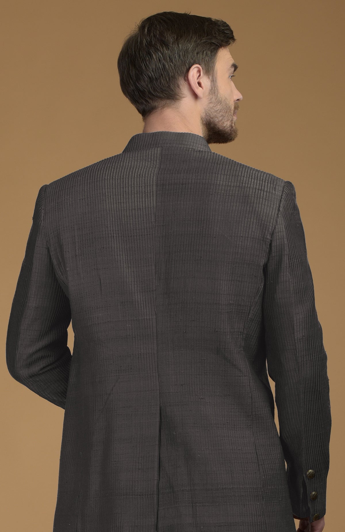 Charcoal grey pintuck raw silk bandhgala jacket, seen from the back.