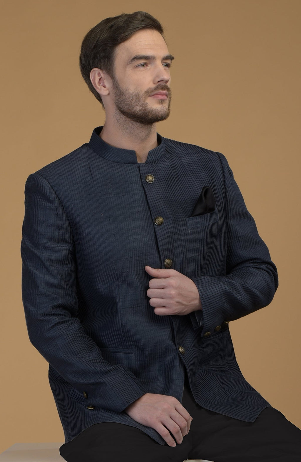 Orion blue pintuck raw silk Bandhgala jacket with a black pocket square.