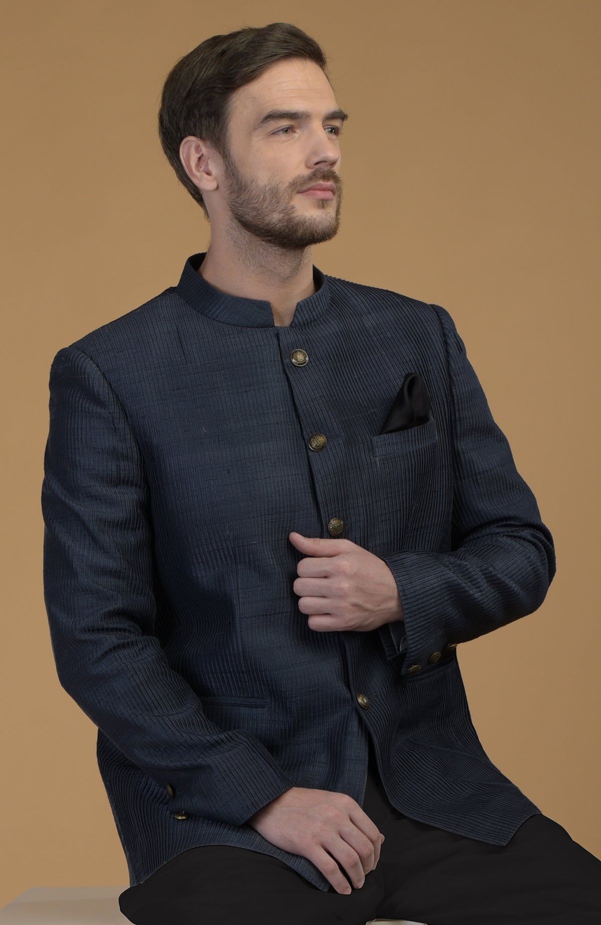 Orion blue pintuck raw silk Bandhgala jacket with a black pocket square.