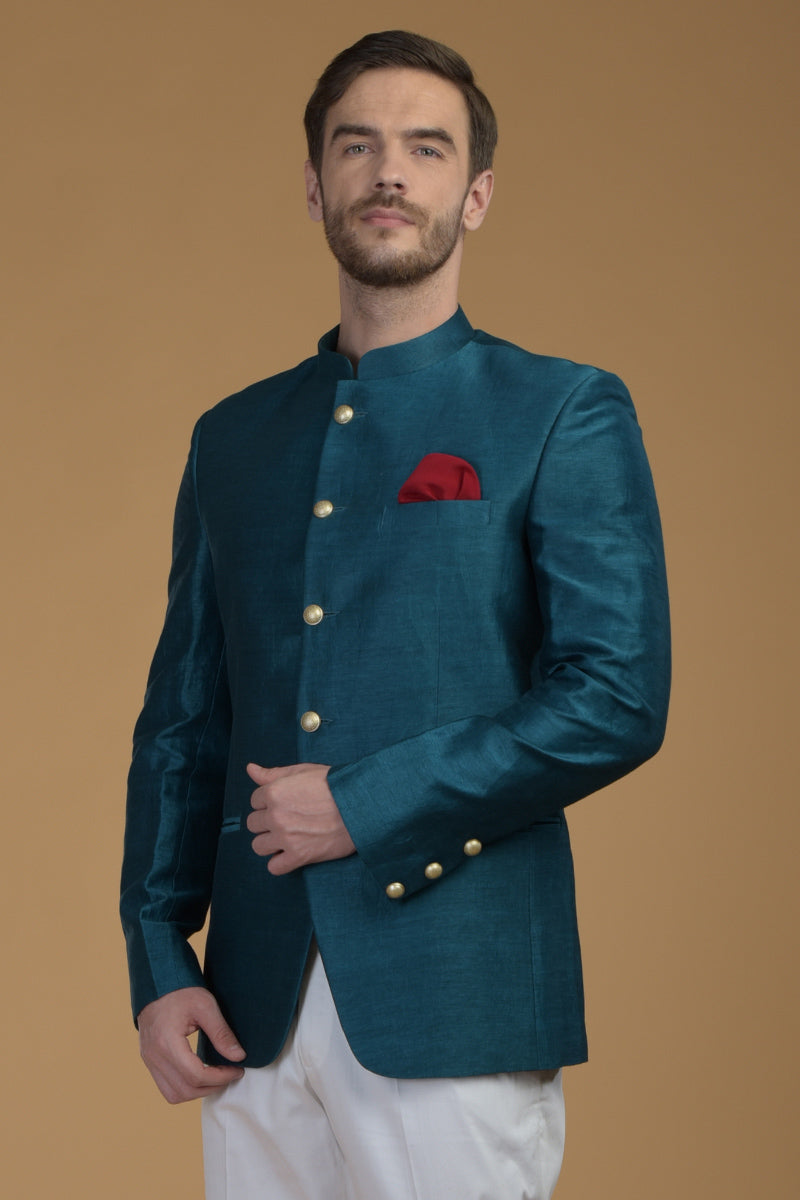 Peacock blue linen silk bandhgala jacket with a red pocket square.