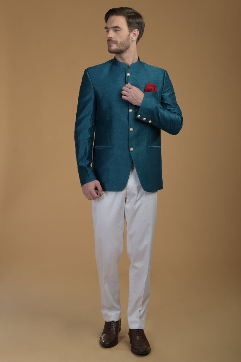 Peacock pink linen silk bandhgala jacket with white pants and brown shoes.