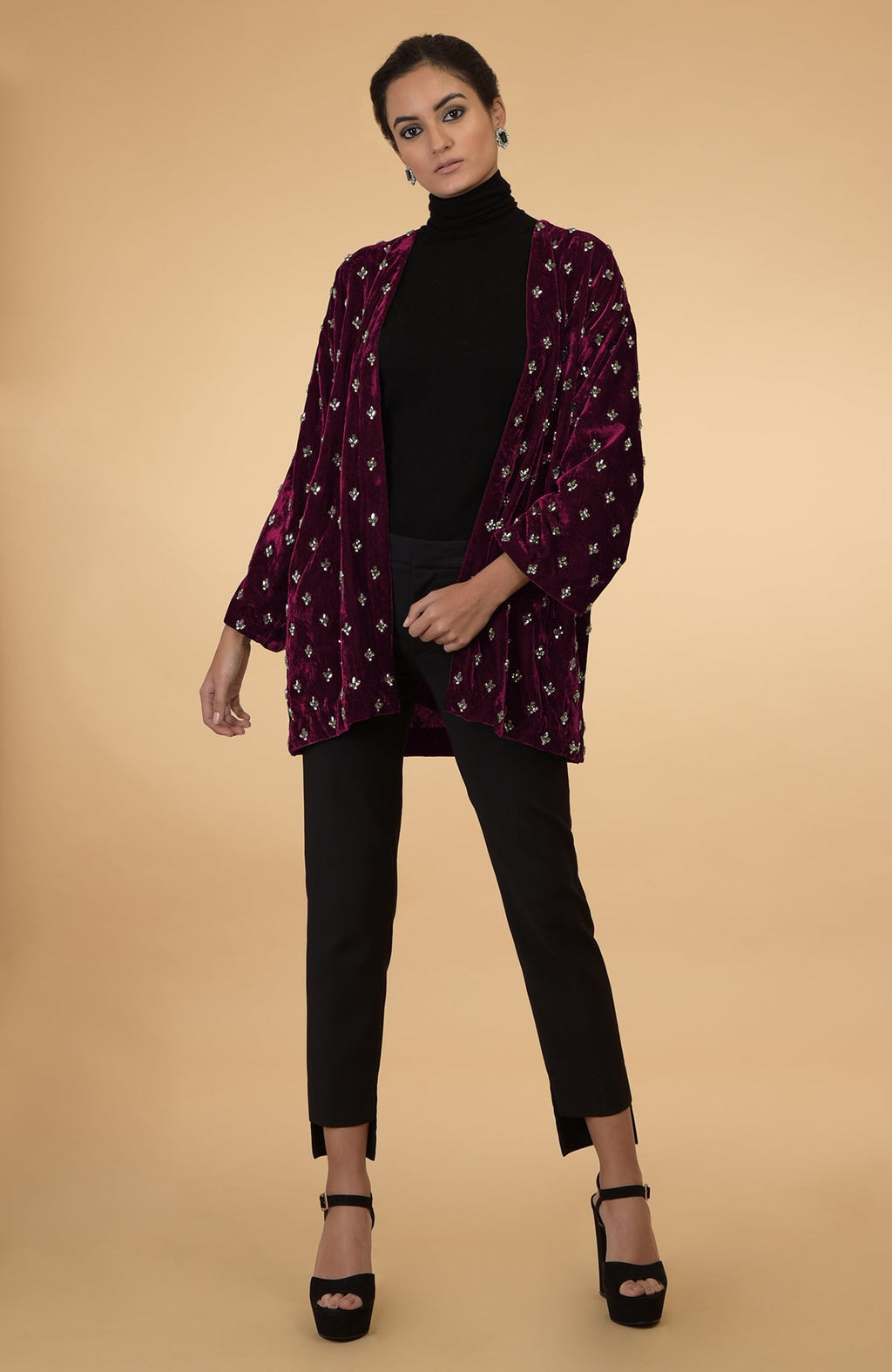 Maroon silk velvet jacket with crystal hand embroidery, worn over a black turtleneck and pants.