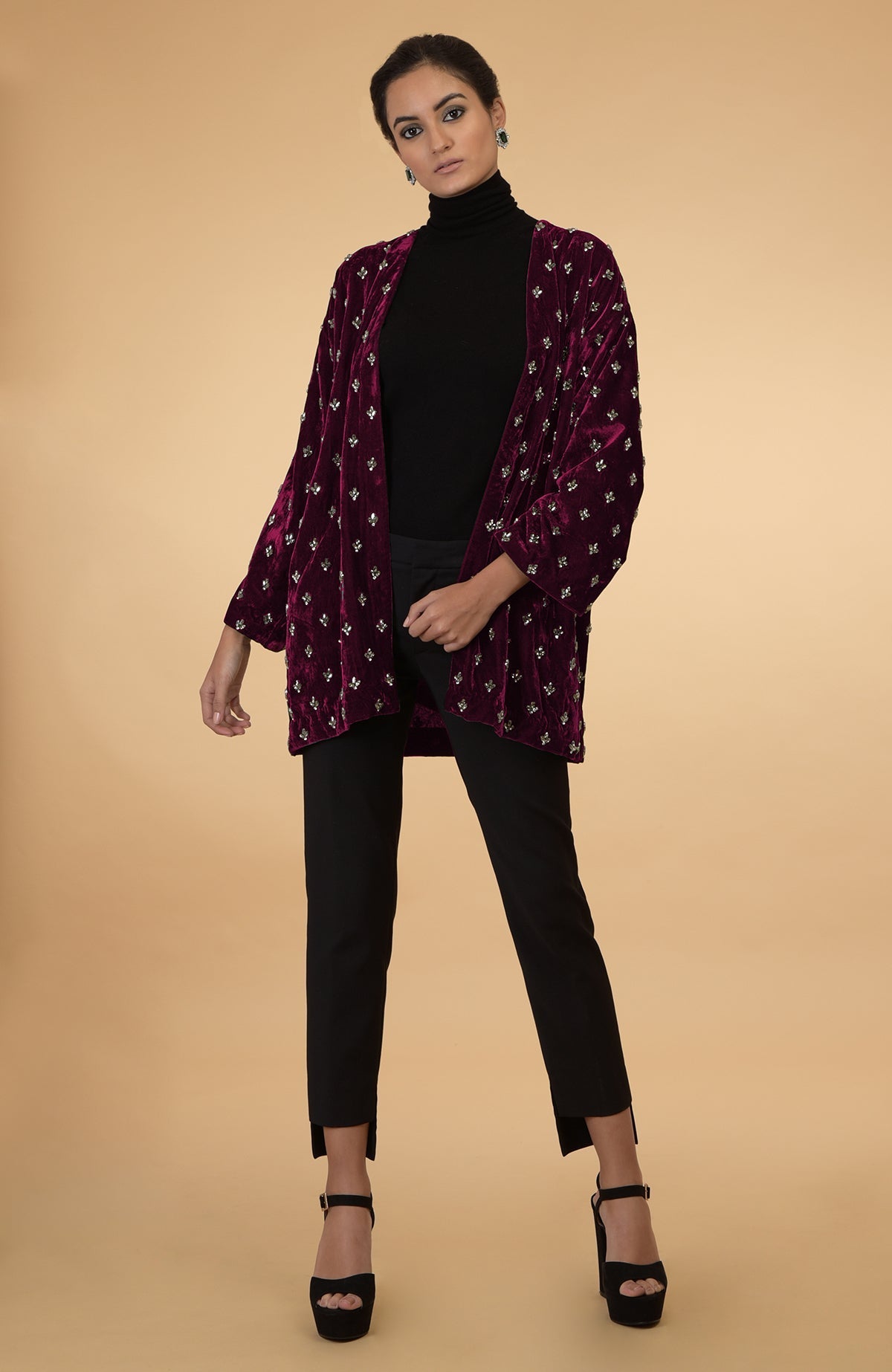 Maroon silk velvet jacket with crystal hand embroidery, worn over a black turtleneck and pants.
