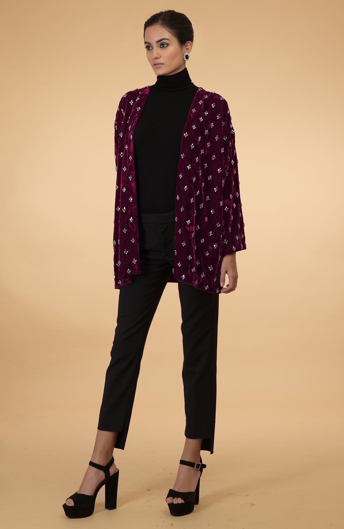 Maroon silk velvet jacket with crystal hand embroidery, worn over a black turtleneck and pants.