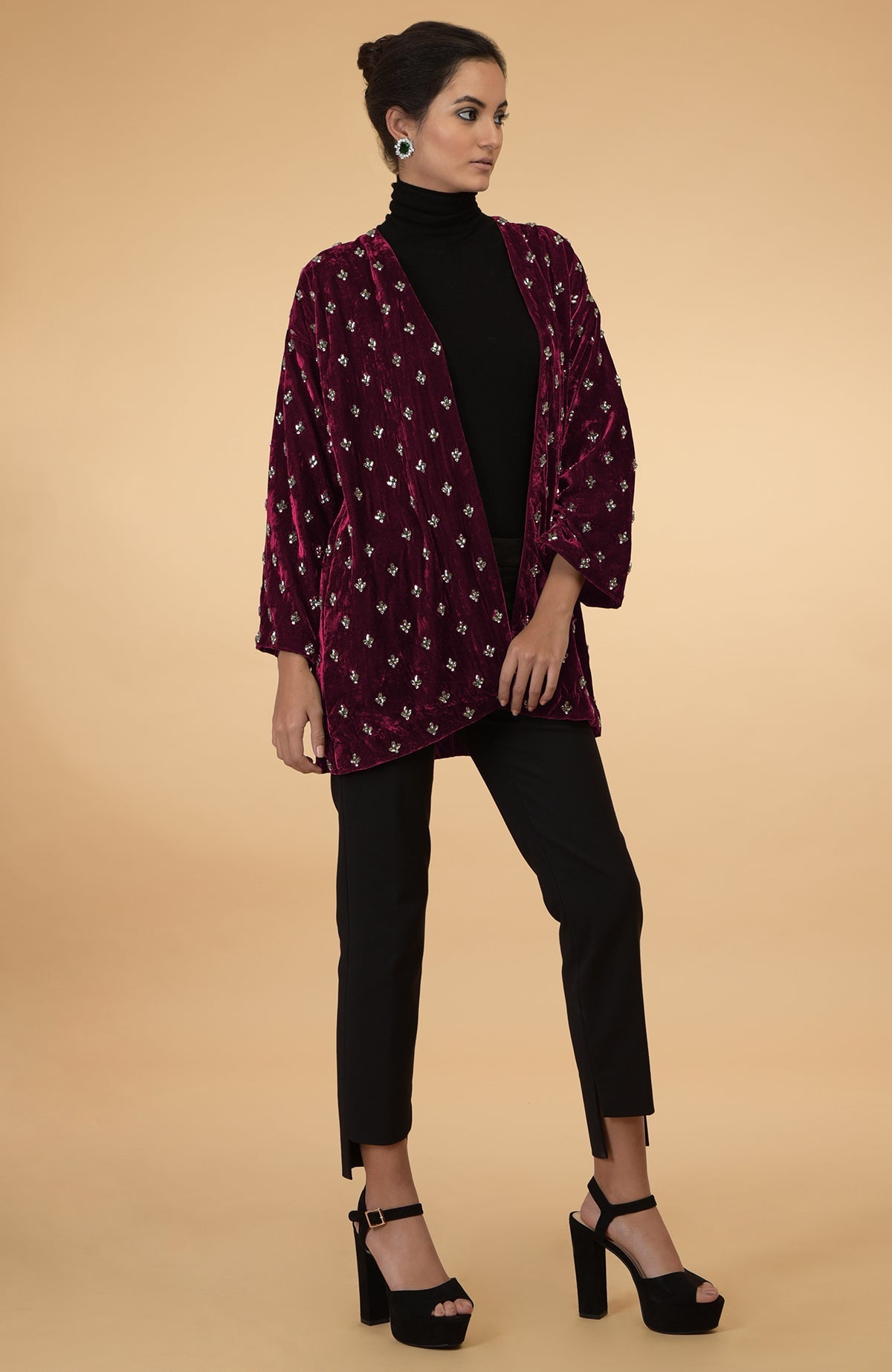 Maroon silk velvet jacket with crystal hand embroidery, worn over a black top and pants.