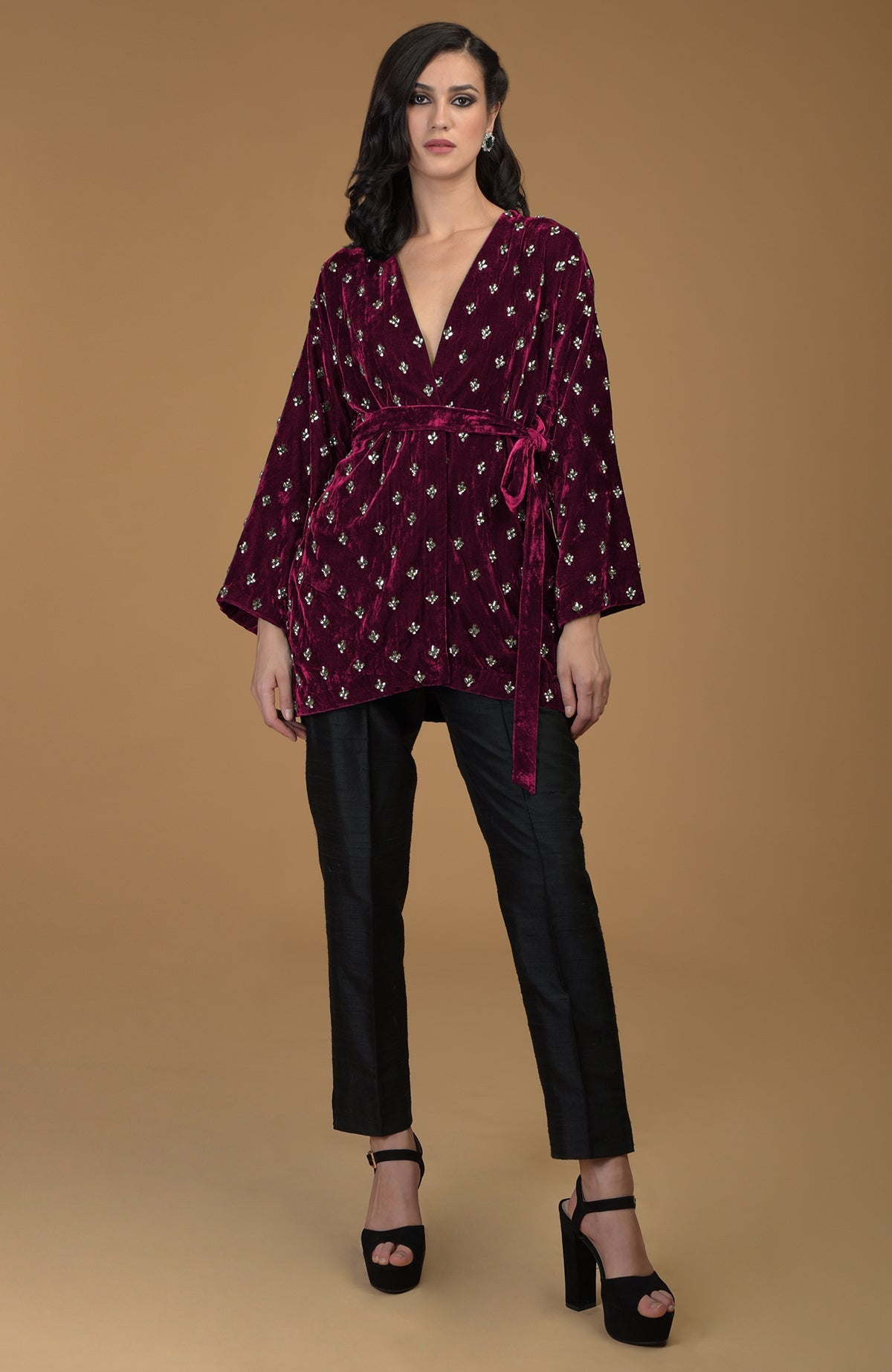Maroon silk velvet jacket with crystal embroidery, black pants, and black platform heels.