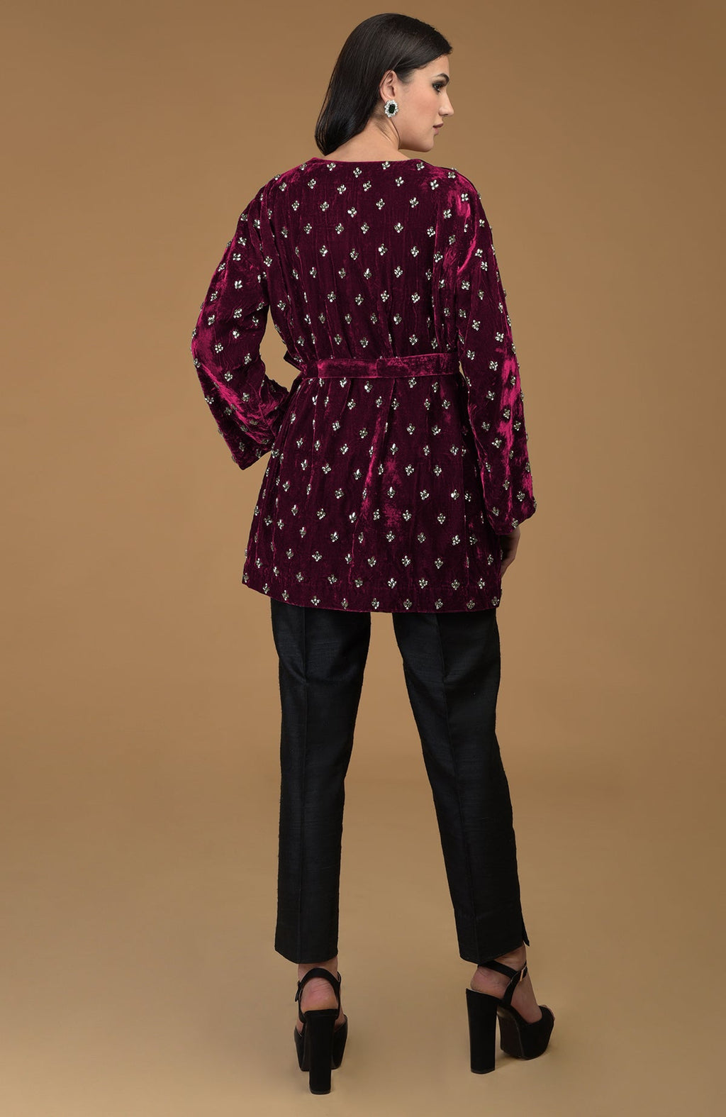 Maroon crystal hand-embroidered silk velvet jacket with a waist belt and black pants.