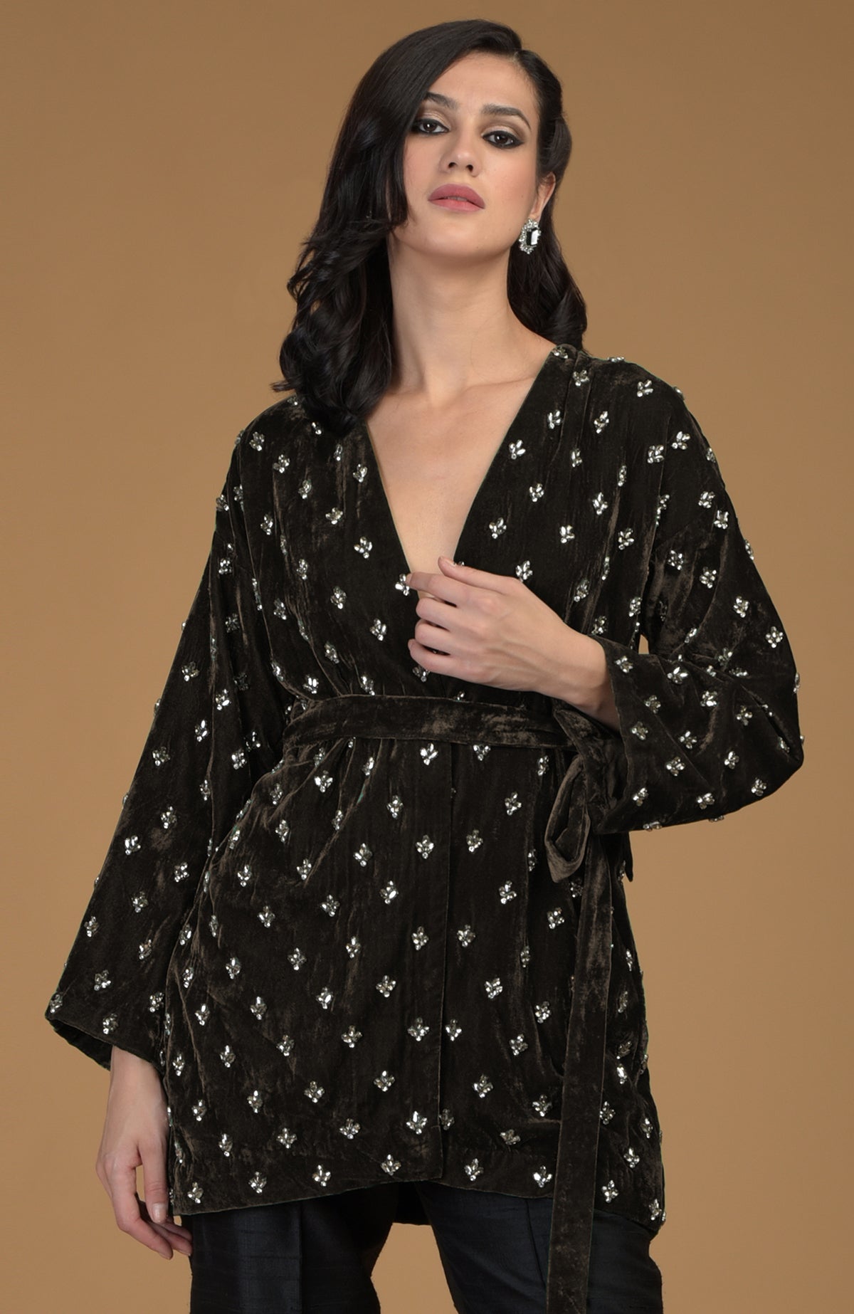 Dark olive silk velvet jacket with crystal hand embroidery and a waist belt.