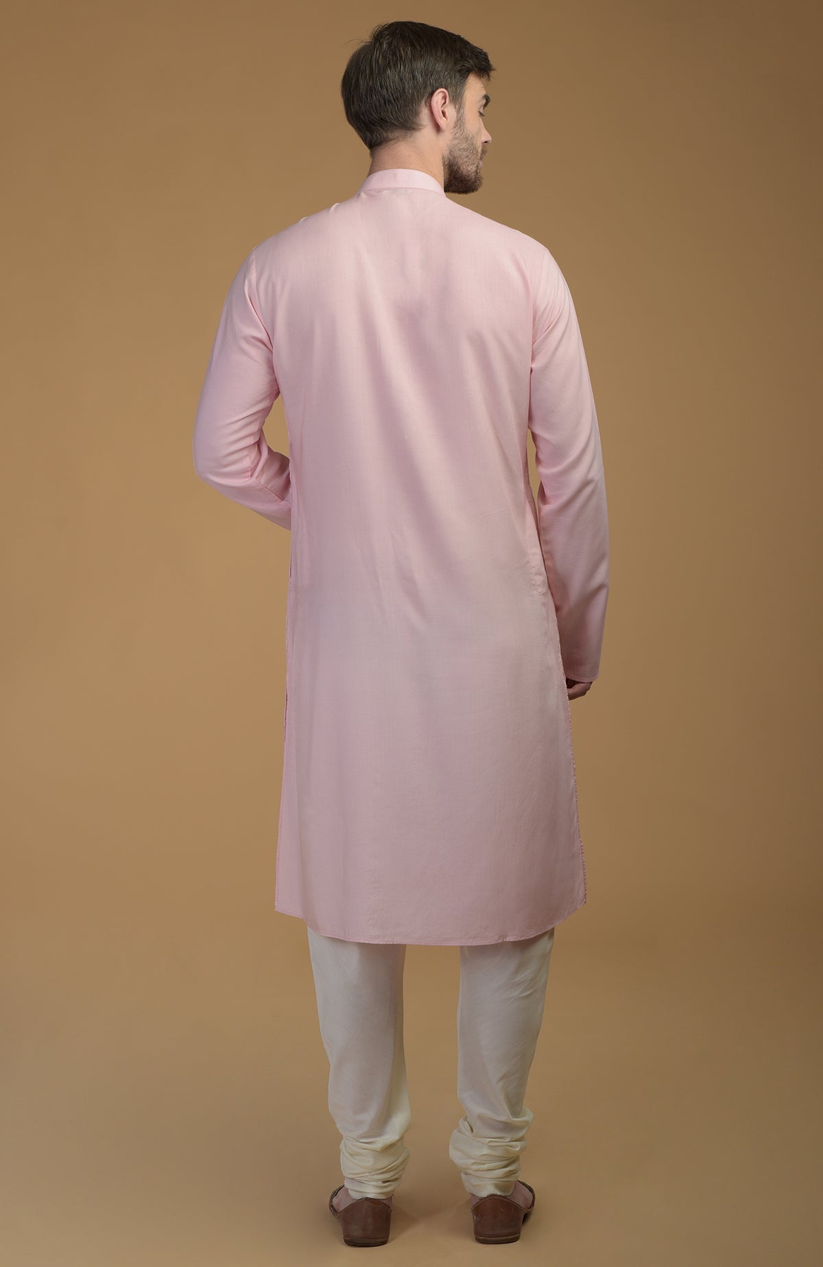 Pale pink kurta with pintuck detail, worn by a man facing away.