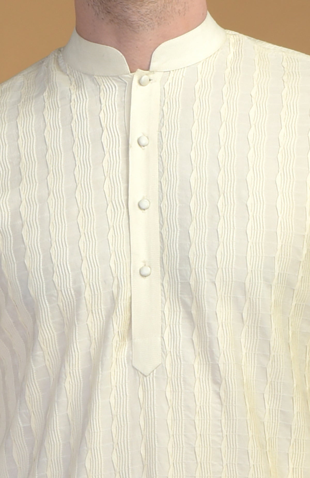 Cream kurta with pintuck and Kantha detail, featuring a band collar and button placket.