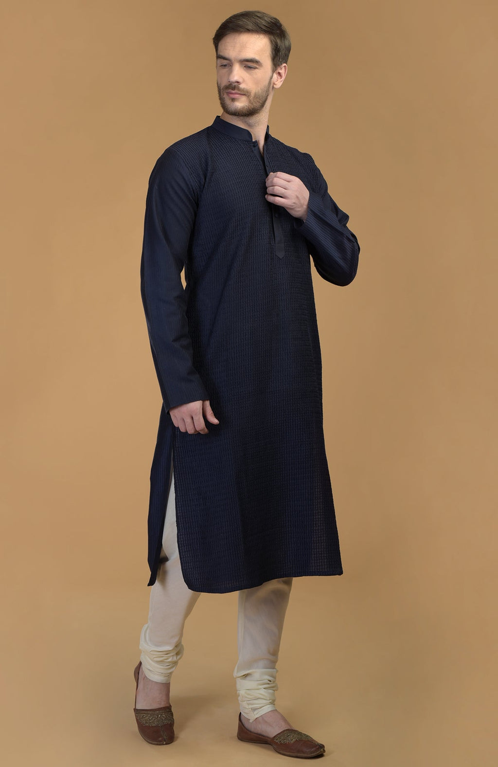 Dark navy kurta with pintuck and kantha detail, paired with ivory churidars.