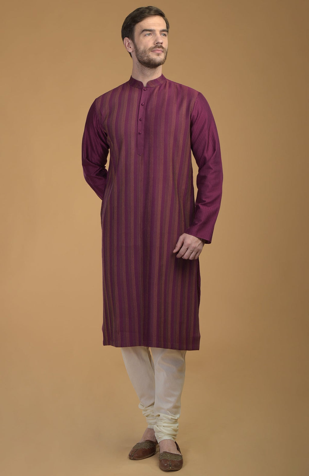 Plum kurta with pintuck and kantha detail, paired with ivory churidar and brown shoes.