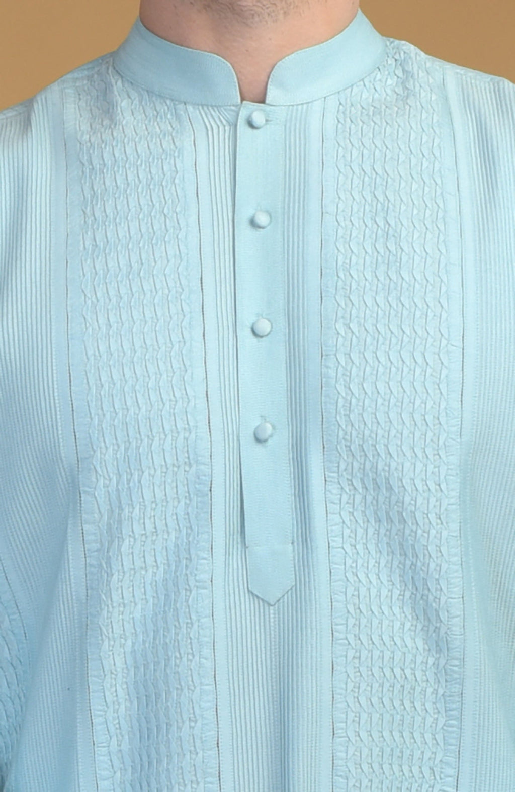 Ice blue kurta with pintuck and kantha details, featuring a band collar and button placket.