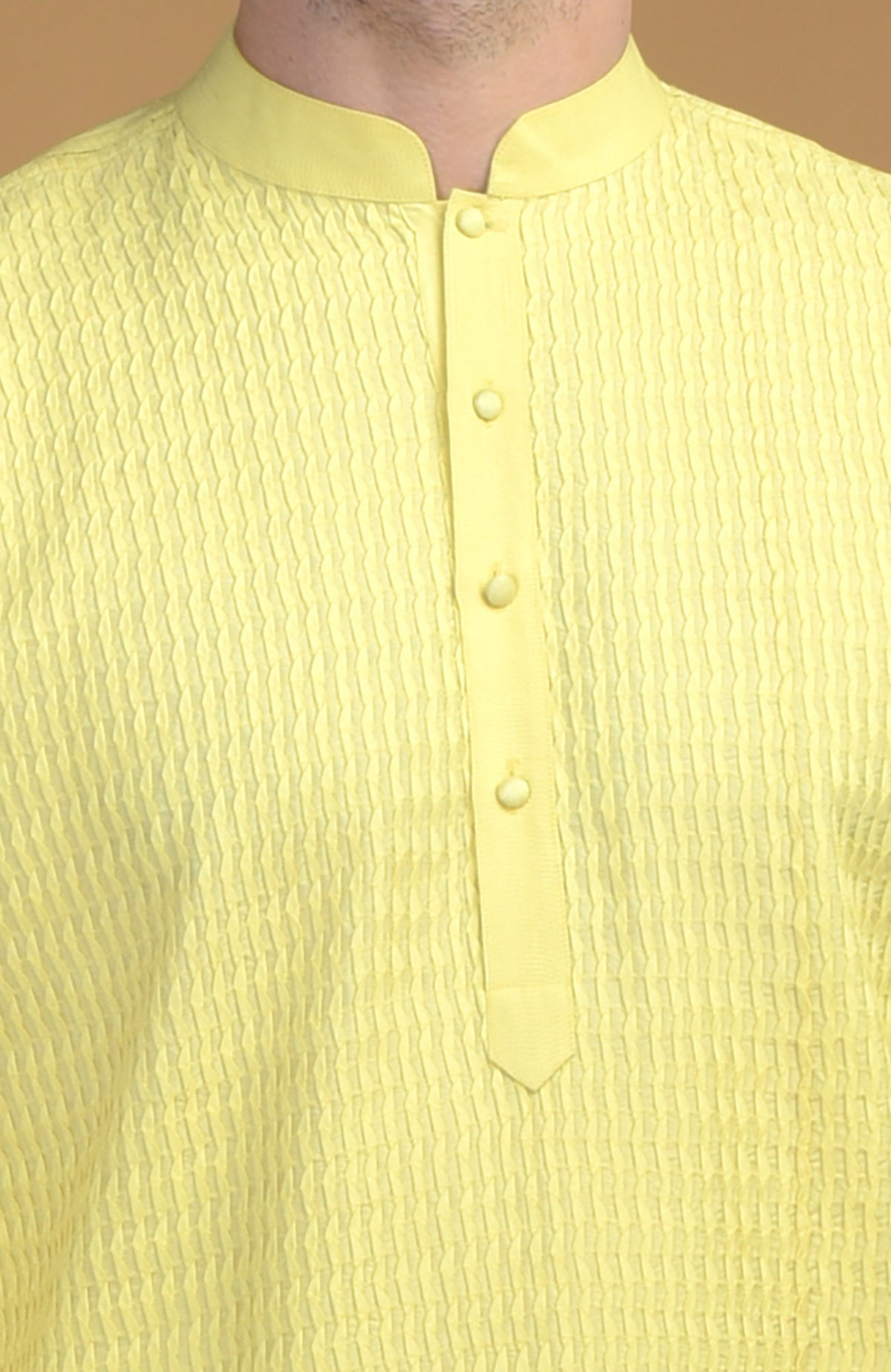A lemon yellow kurta with pintuck and Kantha stitch detail.