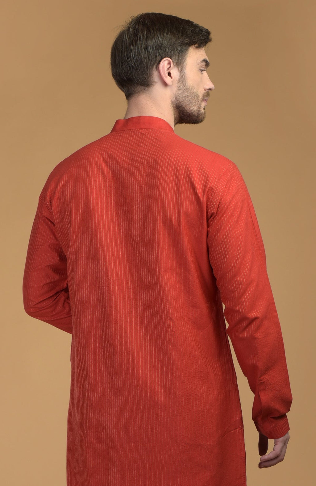 A man from the back wearing a red kurta with pintuck and kantha details.