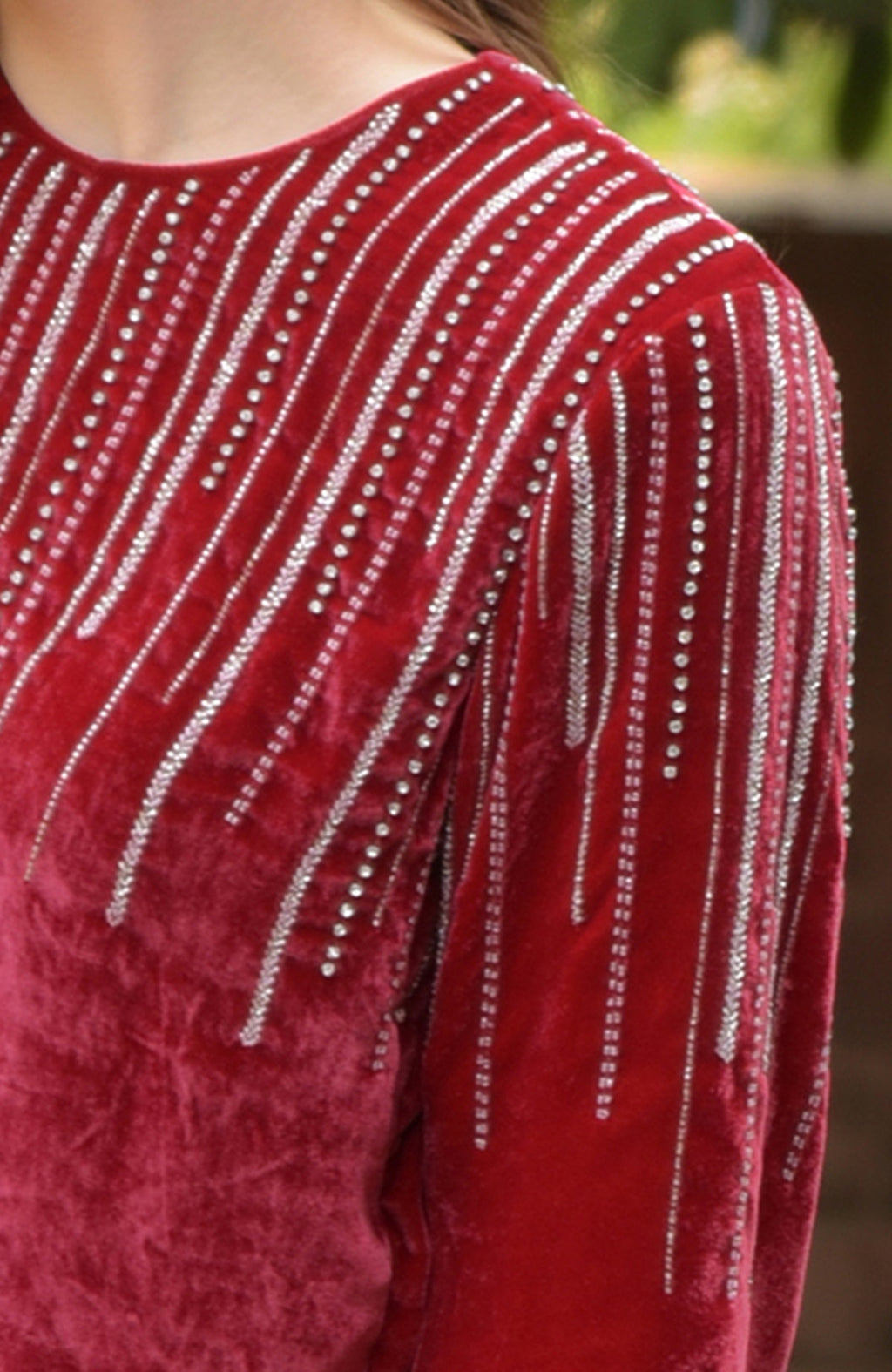 Cherry red velvet kurta with crystal and bead embroidery on the neckline and sleeves.