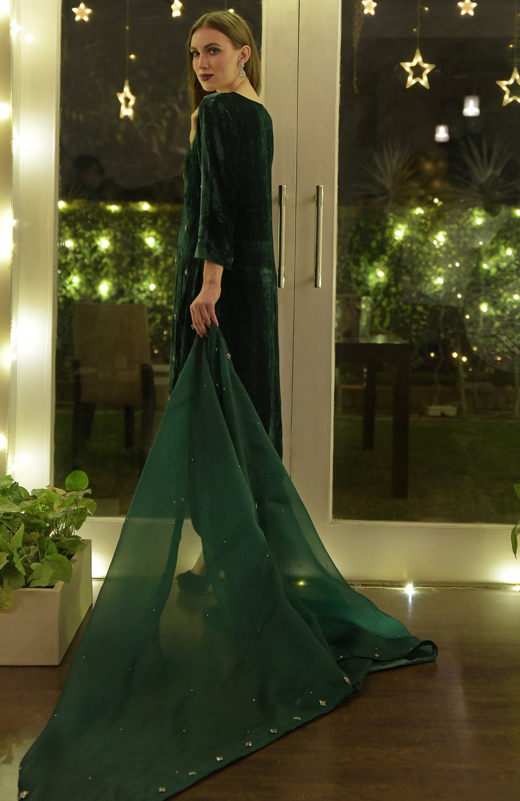 Emerald green velvet kurta set with hand-embroidered details and a sheer dupatta.