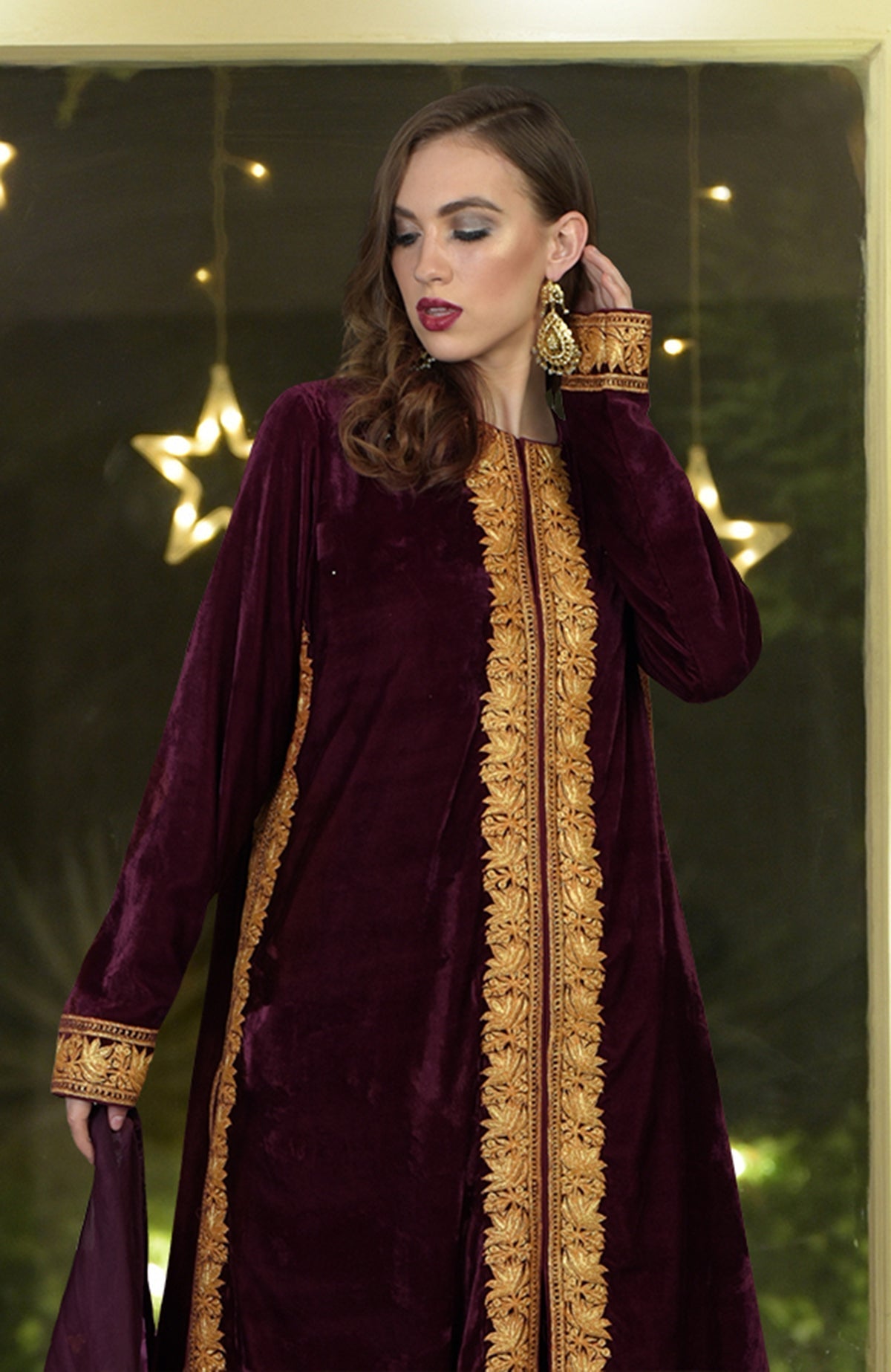 Burgundy velvet kurta with gold tilla embroidery, paired with a matching dupatta.