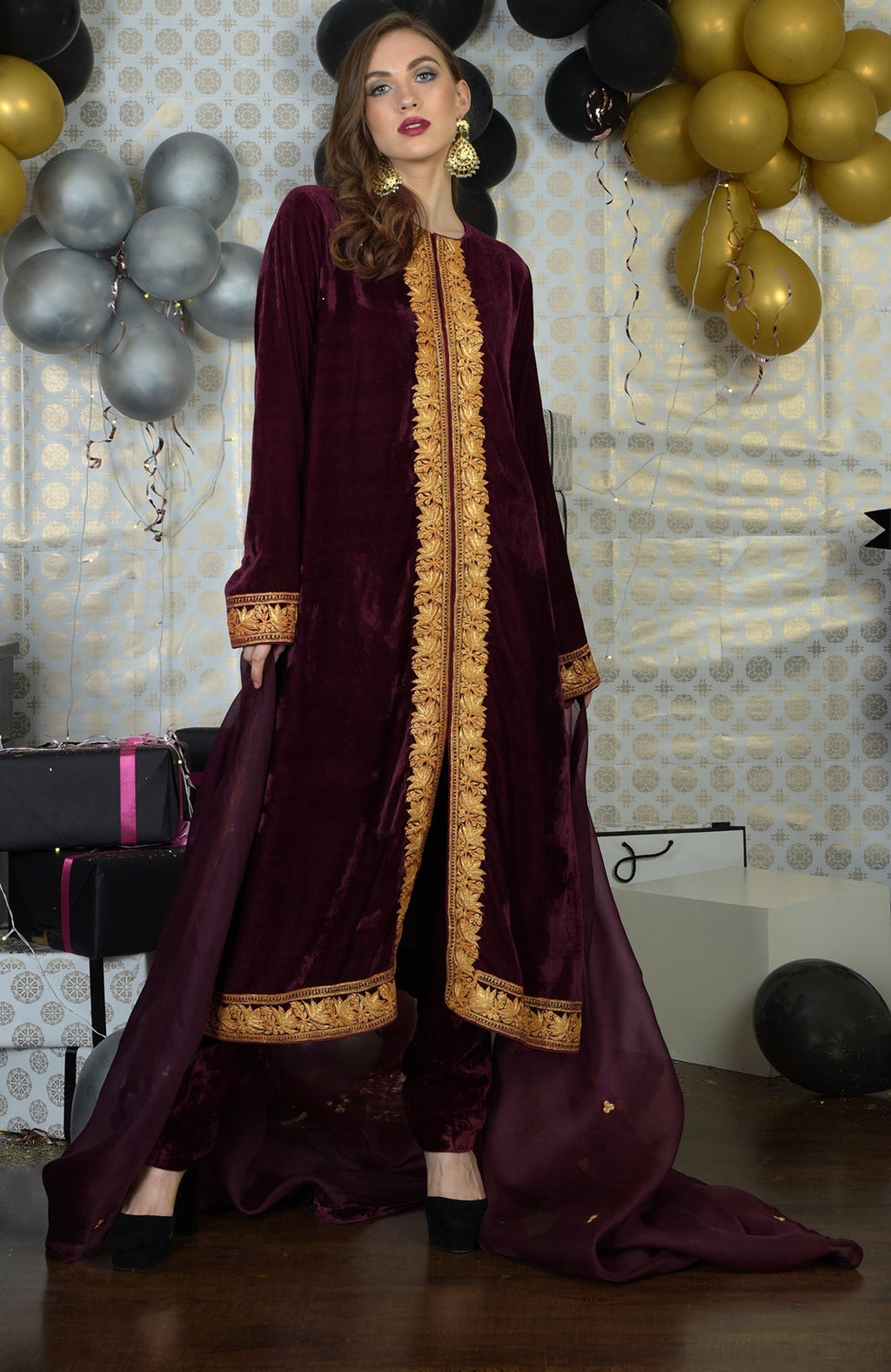 Burgundy velvet kurta set with gold tilla embroidery and matching dupatta.