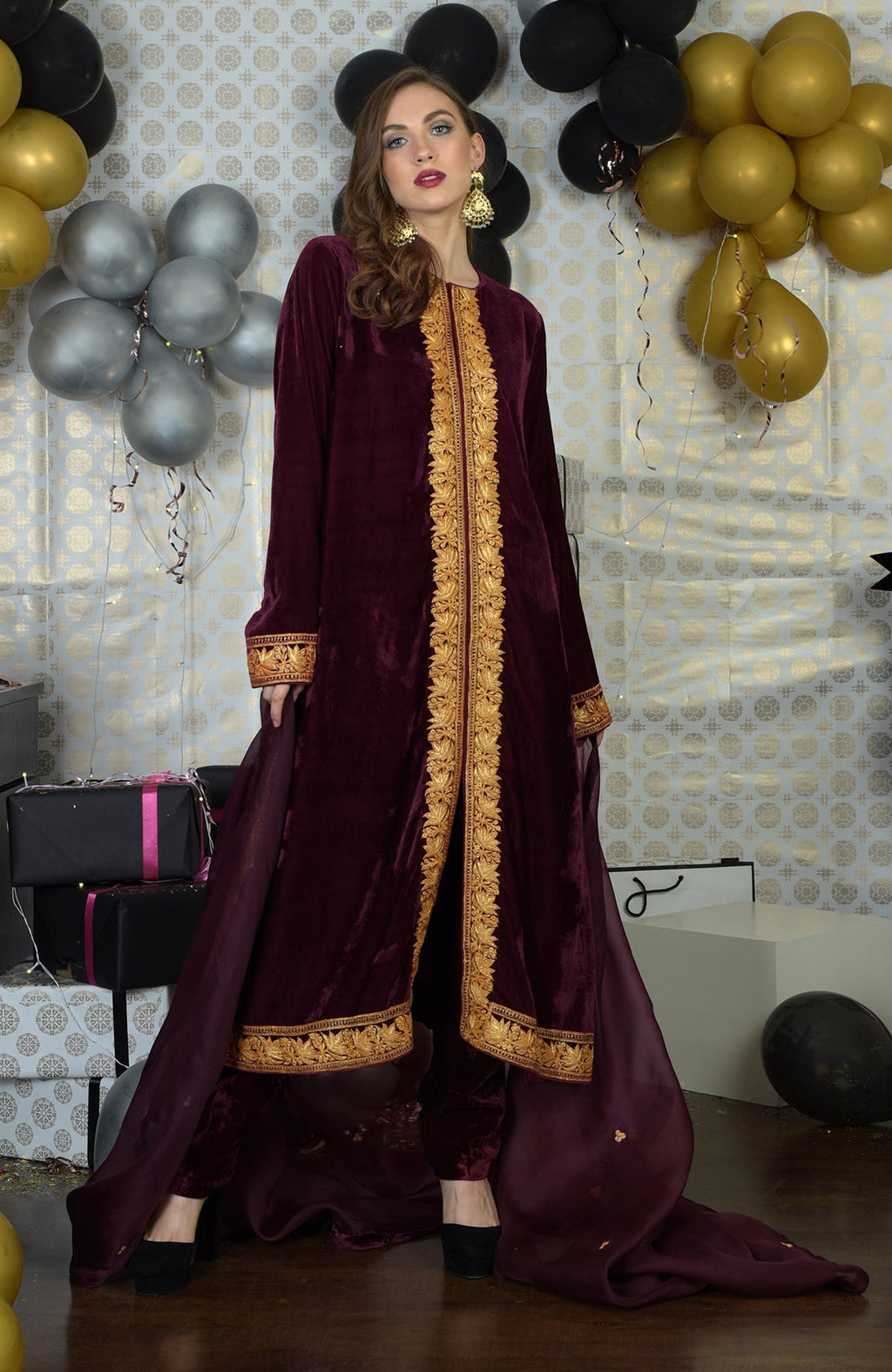 Burgundy velvet kurta set with gold tilla embroidery and matching dupatta.