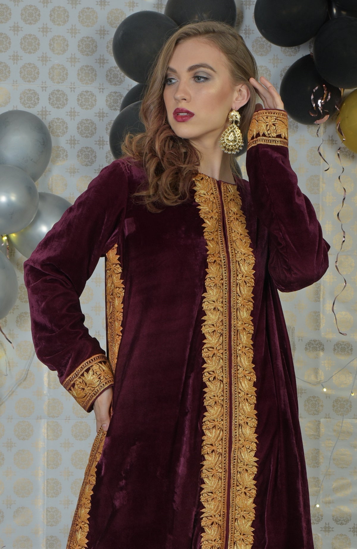 Burgundy velvet kurta with gold tilla embroidery on the front, sides, and cuffs.
