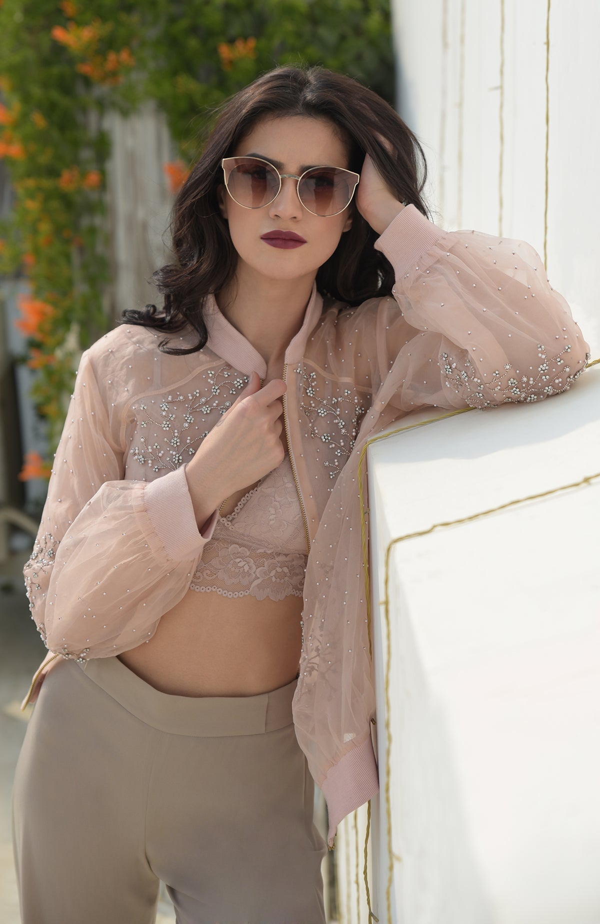 Crystal floweret hand embroidered bomber jacket in peach organza.