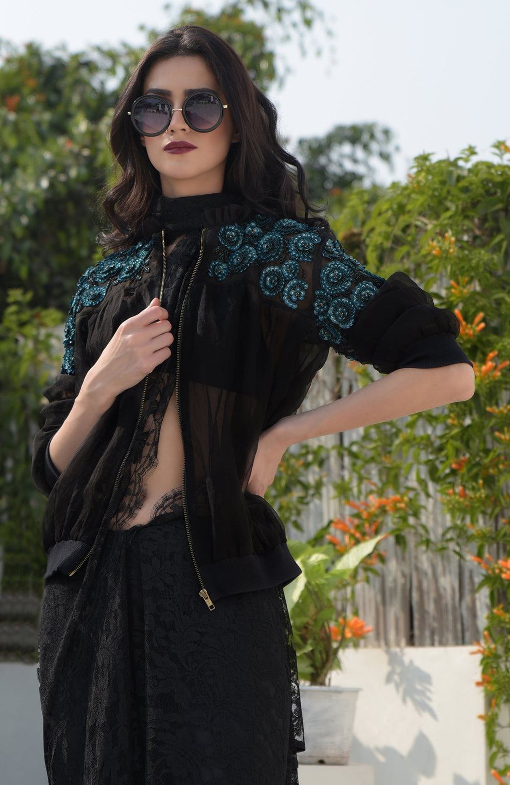 Black organza bomber jacket with blue 3D floral hand embroidery and ribbed cuffs and hem