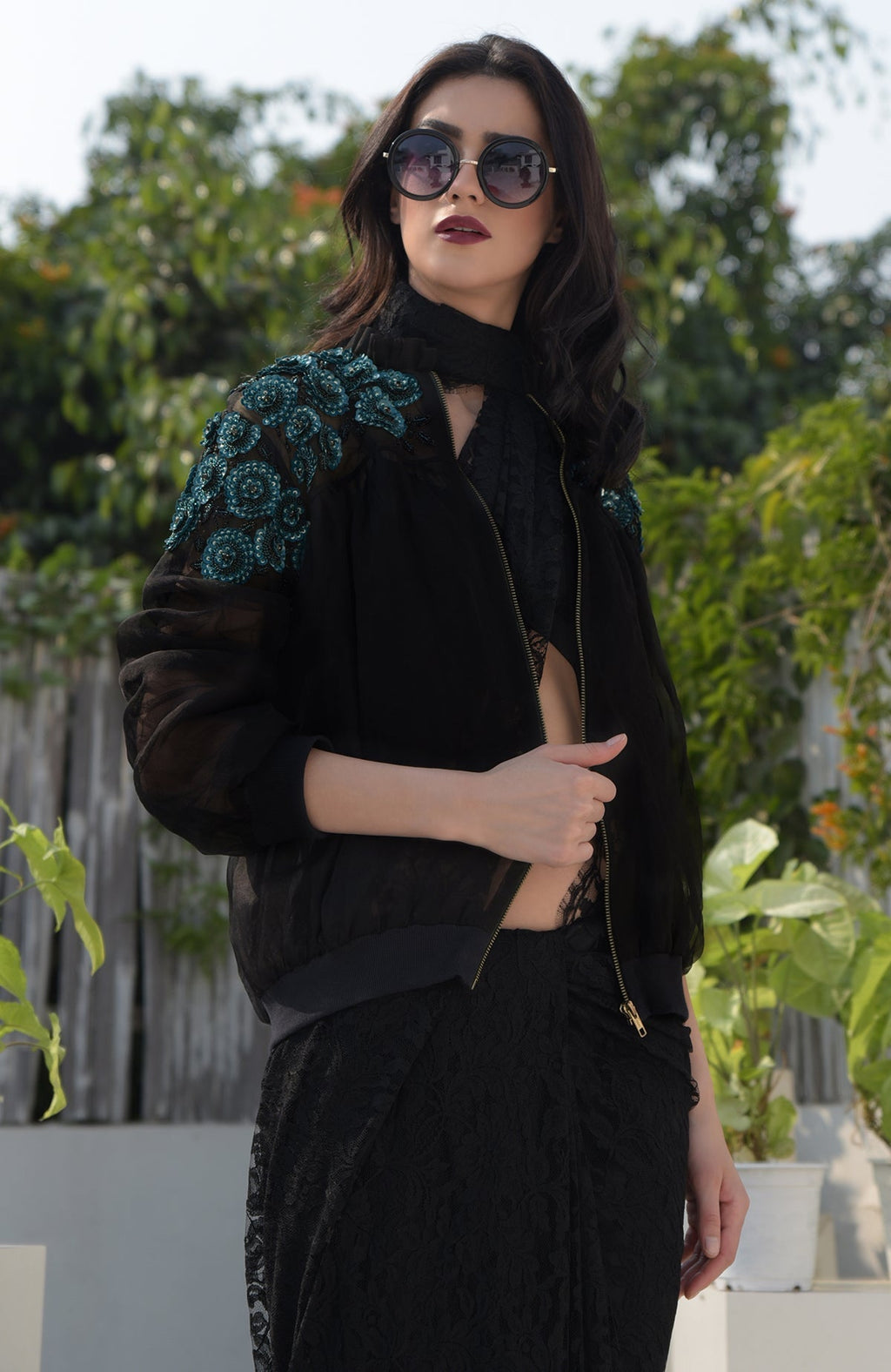Black organza bomber jacket with blue 3D floral hand embroidery.