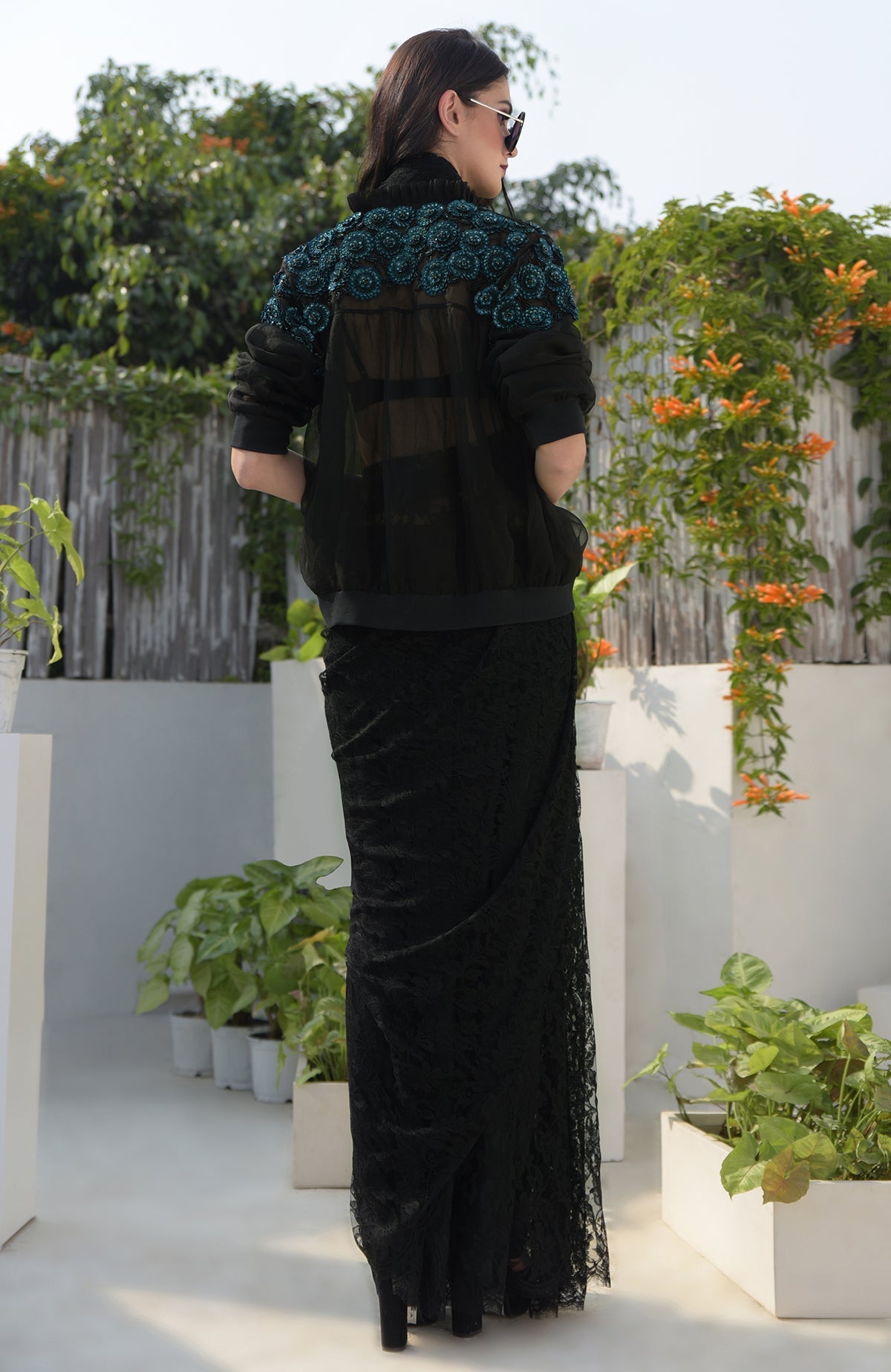 Black organza bomber jacket with blue 3D floral hand embroidery and ribbed cuffs and hem
