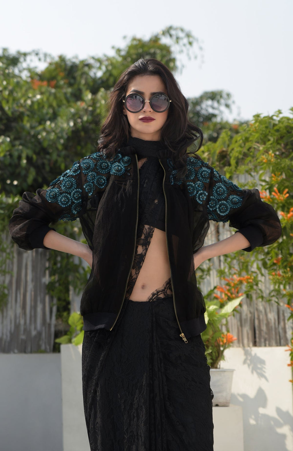 Black organza bomber jacket with blue 3D floral hand embroidery and ribbed cuffs and hem