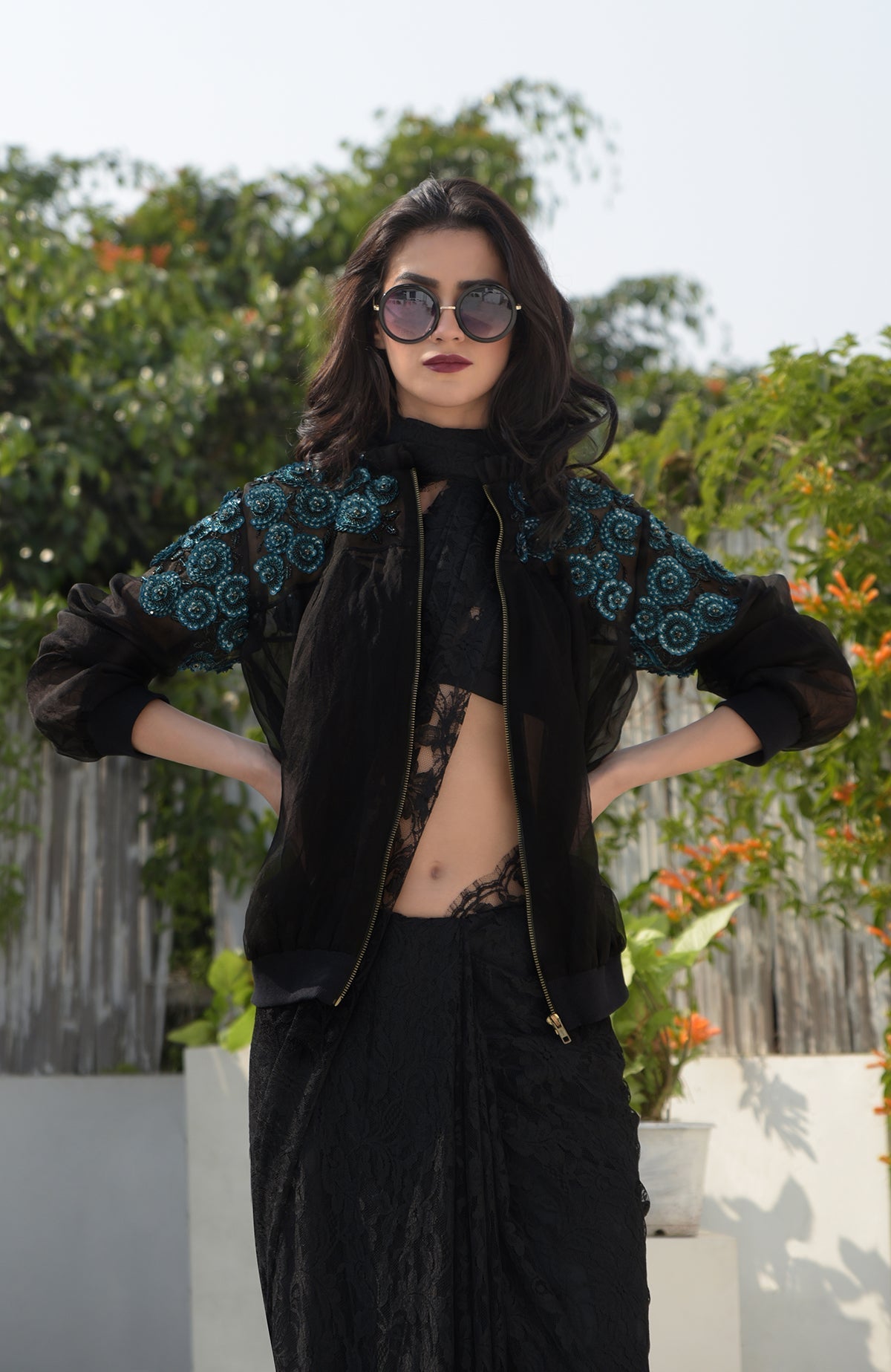 Black organza bomber jacket with blue 3D floral hand embroidery and ribbed cuffs and hem